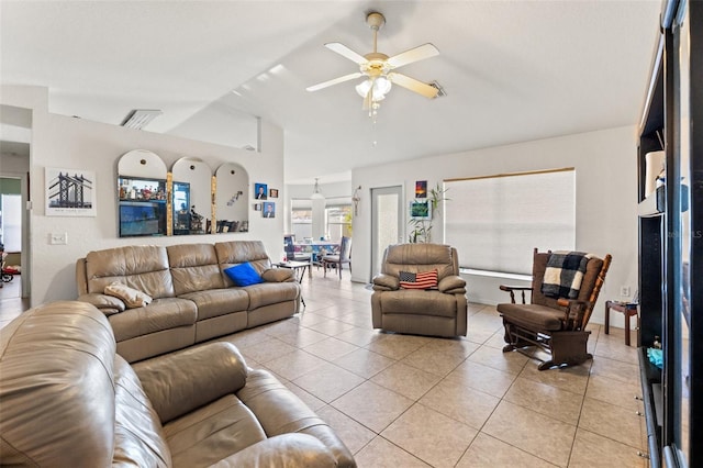 living room featuring light tile patterned floors, vaulted ceiling, and ceiling fan