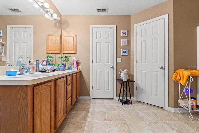 bathroom featuring tile patterned floors and vanity