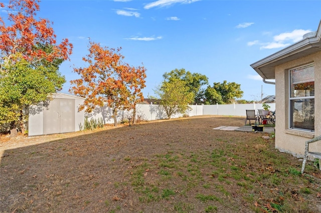 view of yard with a shed and a patio