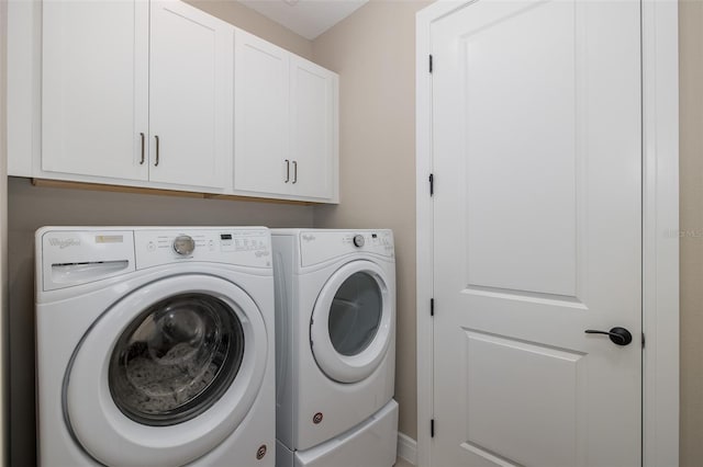 laundry room with cabinets and washer and clothes dryer