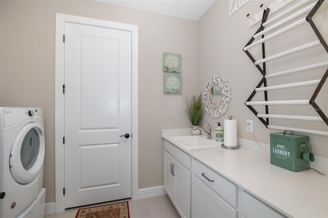 laundry room featuring cabinets, washer / dryer, sink, and light tile patterned floors