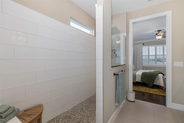 bathroom featuring ceiling fan, tiled shower, ornamental molding, and tile patterned floors