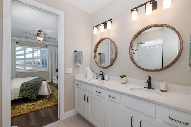 bathroom featuring vanity, crown molding, and ceiling fan