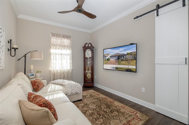 living room featuring dark hardwood / wood-style flooring, crown molding, a barn door, and ceiling fan