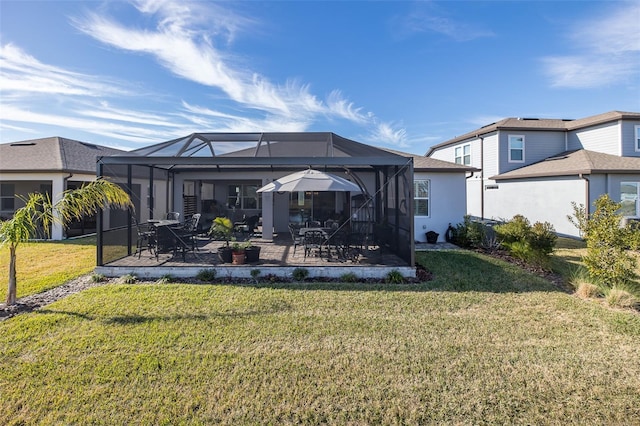 back of house featuring a yard, a patio, and glass enclosure