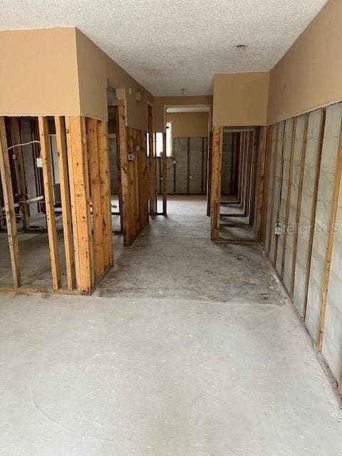 interior space with a textured ceiling and concrete floors