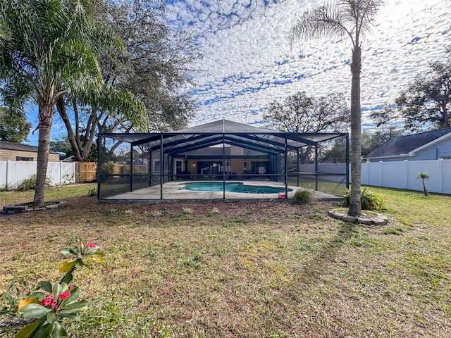 view of yard with a lanai, a fenced in pool, a patio, and a fenced backyard