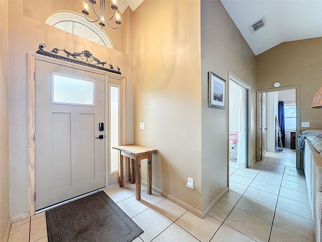 foyer entrance with light tile patterned flooring, baseboards, visible vents, and a chandelier