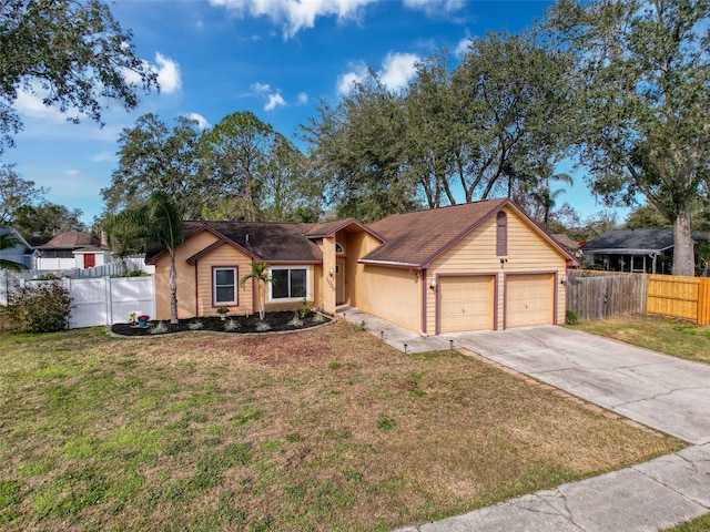 ranch-style house with a garage, concrete driveway, a front yard, and fence