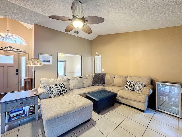 living room featuring lofted ceiling, light tile patterned floors, and a healthy amount of sunlight