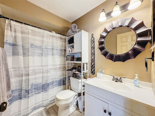 full bath with toilet, vanity, and tile patterned flooring