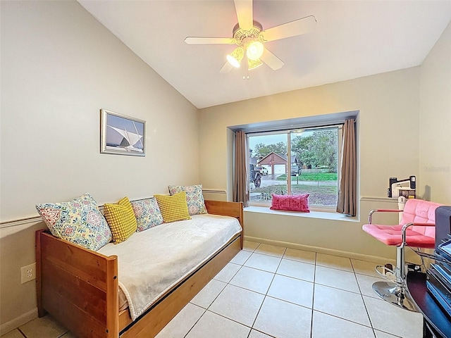 living room featuring light tile patterned floors, ceiling fan, baseboards, and lofted ceiling