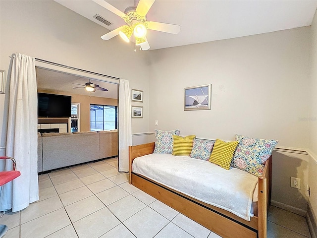 bedroom featuring light tile patterned flooring, visible vents, and ceiling fan