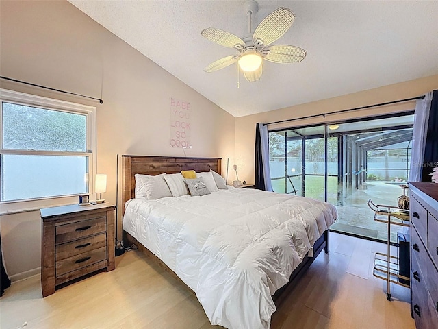 bedroom with light wood finished floors, lofted ceiling, a ceiling fan, and access to outside