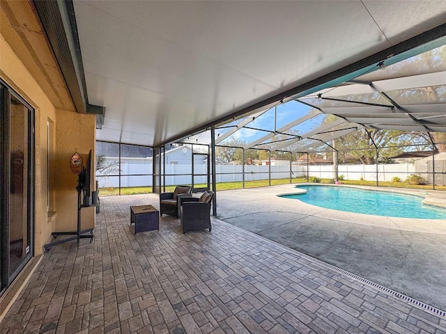 view of swimming pool with a fenced in pool, a patio, a fenced backyard, and glass enclosure