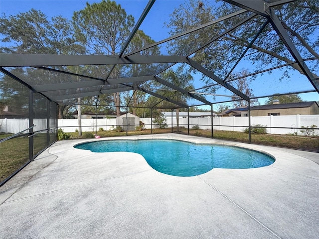 view of swimming pool with a lanai, a fenced in pool, a fenced backyard, and a patio area