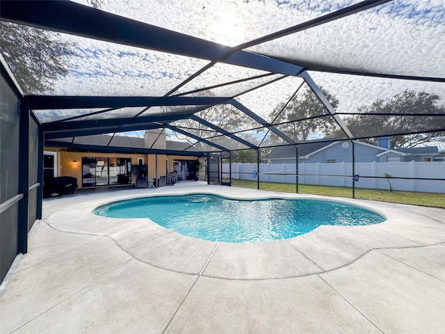 view of swimming pool featuring a patio area, a fenced in pool, a lanai, and fence