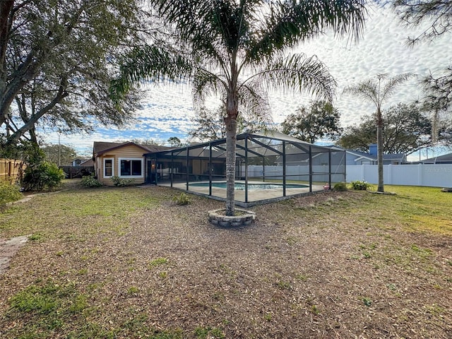 view of yard with a fenced in pool, a lanai, and fence