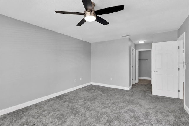 5925 Seaside Dr, New Port Richey, FL 34652 - unfurnished bedroom featuring ceiling fan, carpet floors, a closet, and a walk in closet
