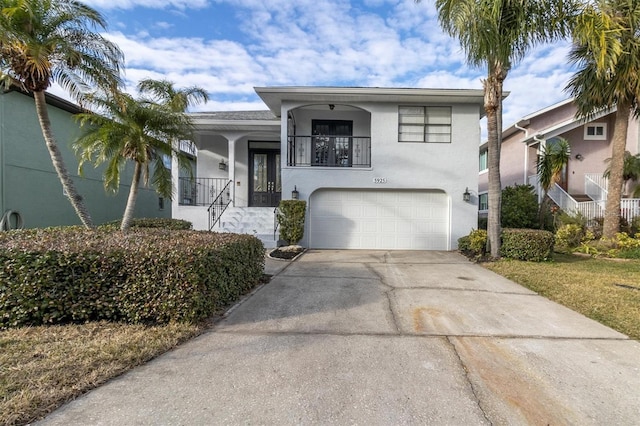 5925 Seaside Dr, New Port Richey, FL 34652 - view of front facade featuring a garage and a balcony