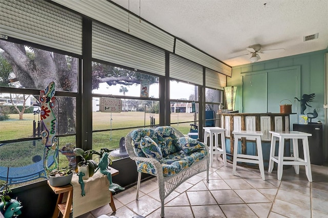 sunroom featuring a wealth of natural light and ceiling fan