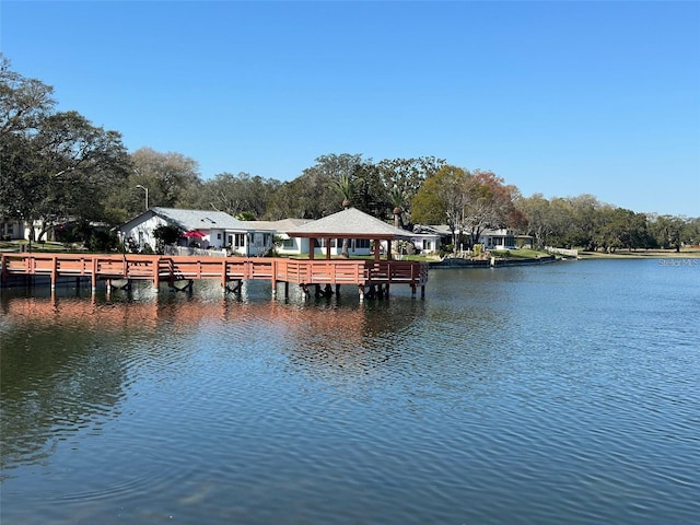 view of dock featuring a gazebo and a water view