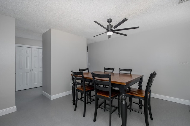 dining space with ceiling fan, concrete floors, and a textured ceiling