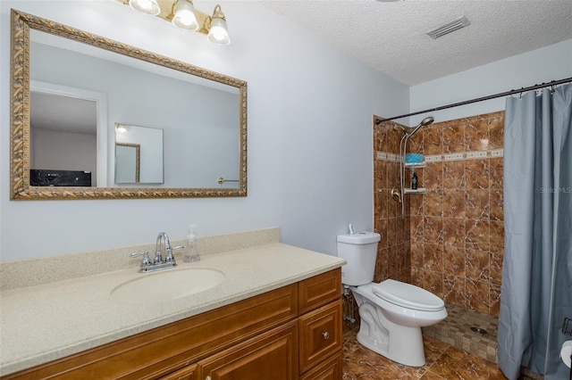 bathroom featuring vanity, walk in shower, a textured ceiling, and toilet