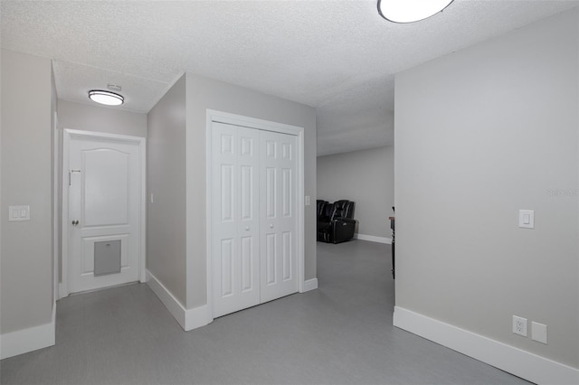 hallway with a textured ceiling