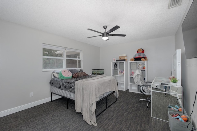 carpeted bedroom with ceiling fan and a textured ceiling