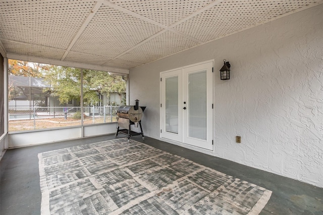 unfurnished sunroom with french doors