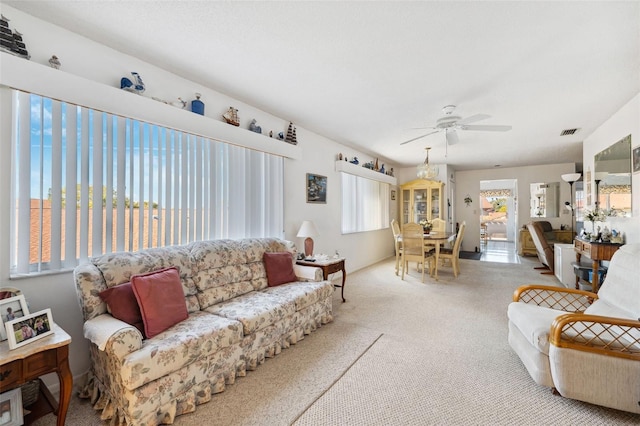 carpeted living room featuring ceiling fan