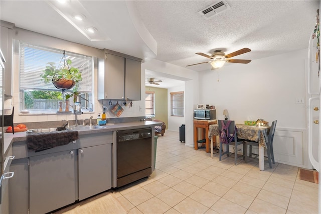 kitchen with dishwasher, plenty of natural light, gray cabinetry, and light tile patterned floors