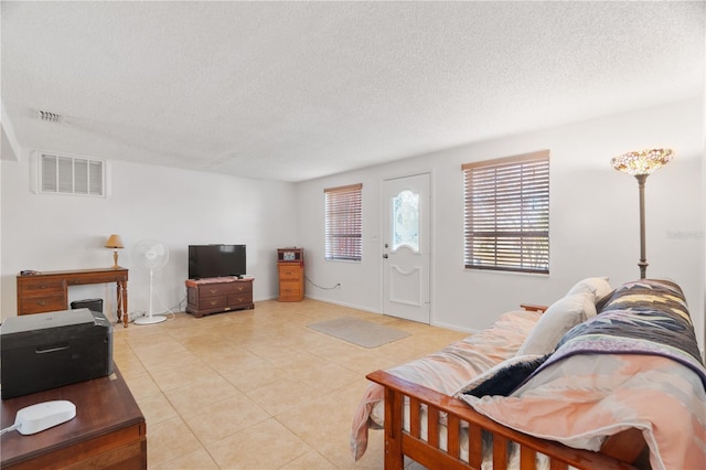 living room with light tile patterned floors and a textured ceiling