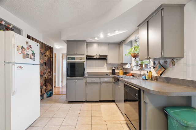 kitchen with gray cabinets, sink, light tile patterned floors, and black appliances