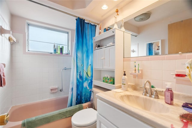 full bathroom featuring toilet, tasteful backsplash, tile walls, vanity, and shower / bath combo with shower curtain