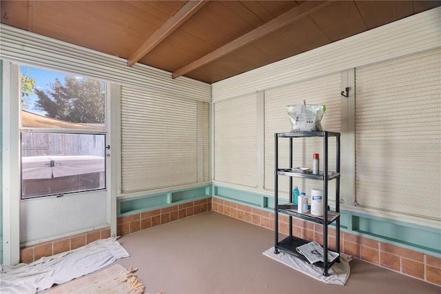 unfurnished sunroom featuring wood ceiling and beamed ceiling