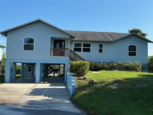 view of front of house with a carport and a front lawn