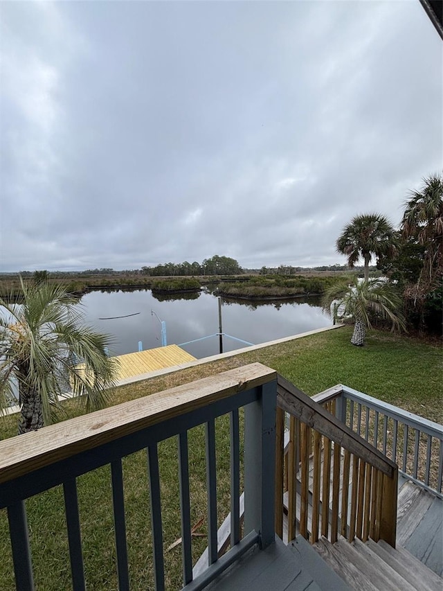 deck featuring a lawn and a water view