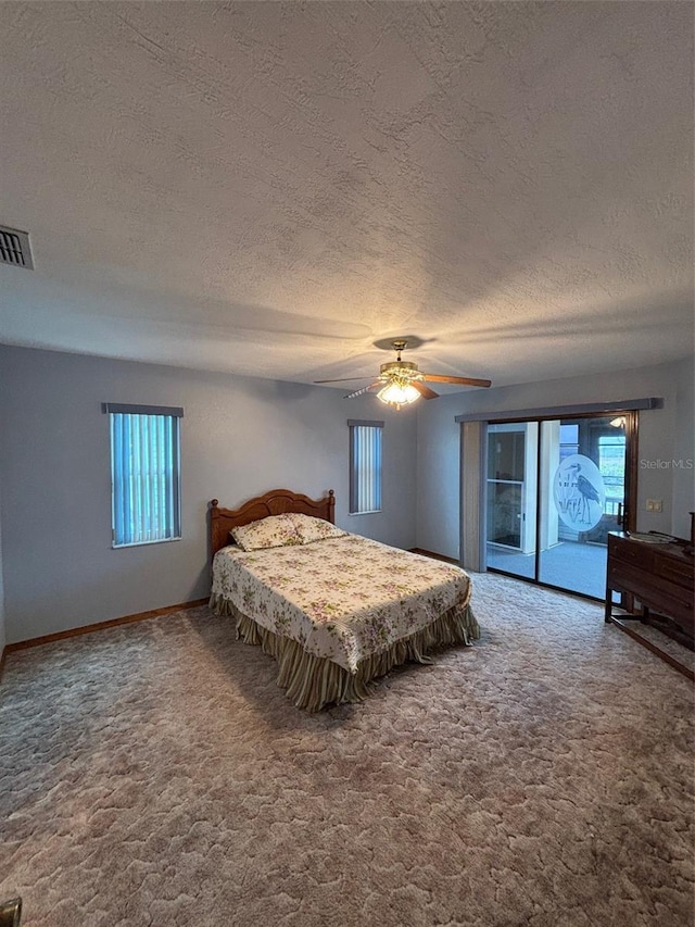 carpeted bedroom featuring a textured ceiling, access to exterior, and ceiling fan