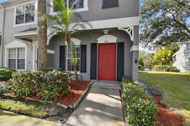 property entrance featuring a yard