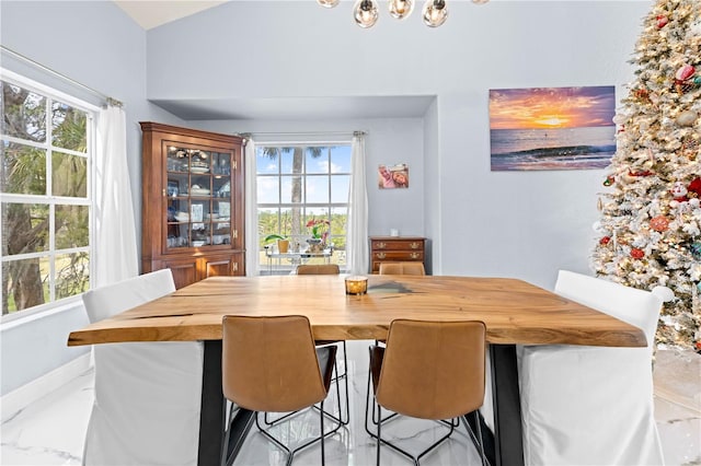 dining area featuring vaulted ceiling