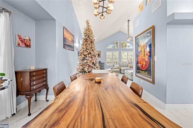 dining room with vaulted ceiling and a chandelier