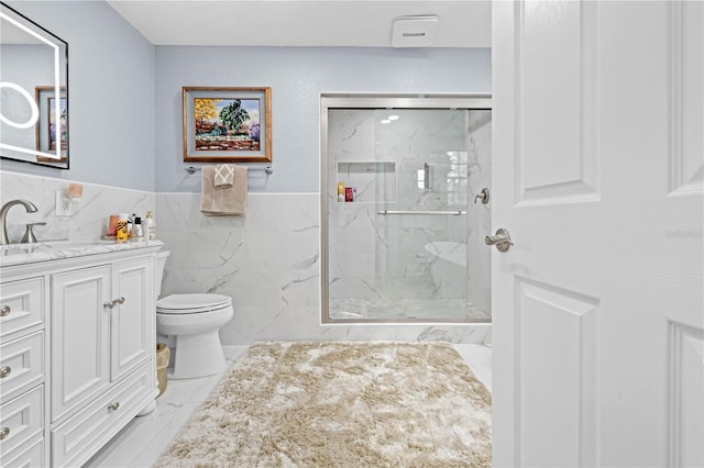 bathroom featuring vanity, toilet, an enclosed shower, and tile walls