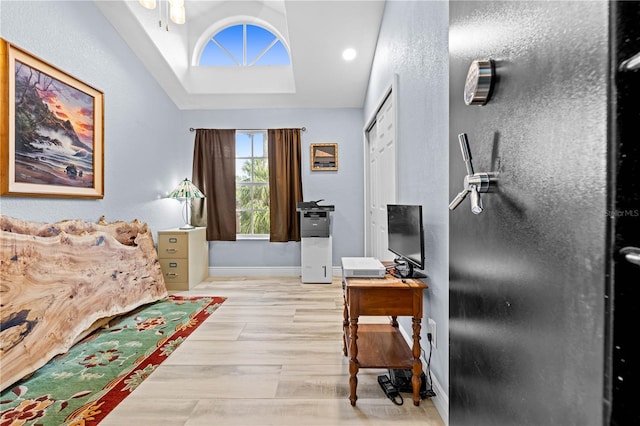 foyer entrance with lofted ceiling and light hardwood / wood-style flooring