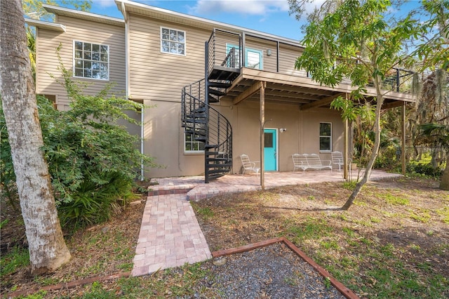 back of property with a patio