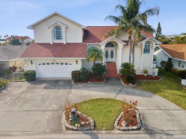 view of front of property with a garage and a front yard