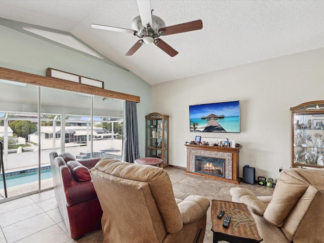 tiled living room with ceiling fan, lofted ceiling, and a textured ceiling