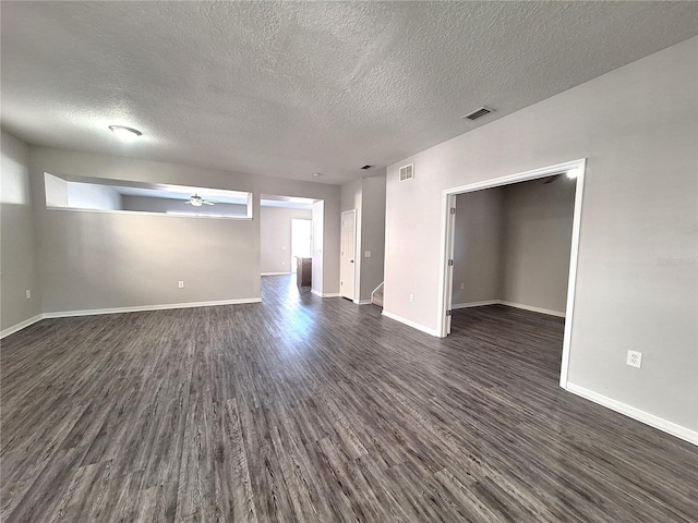 unfurnished room featuring ceiling fan, a textured ceiling, and dark hardwood / wood-style flooring