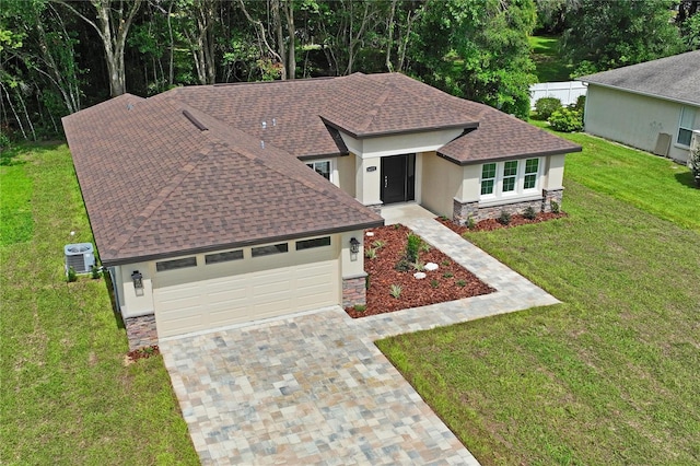 view of front of house with a front yard and central air condition unit